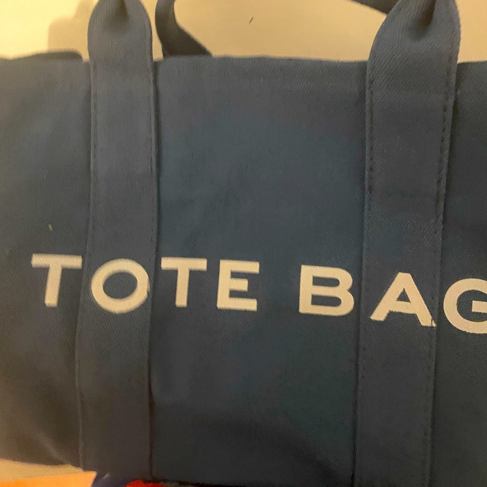 Blue with white lettering tote bag